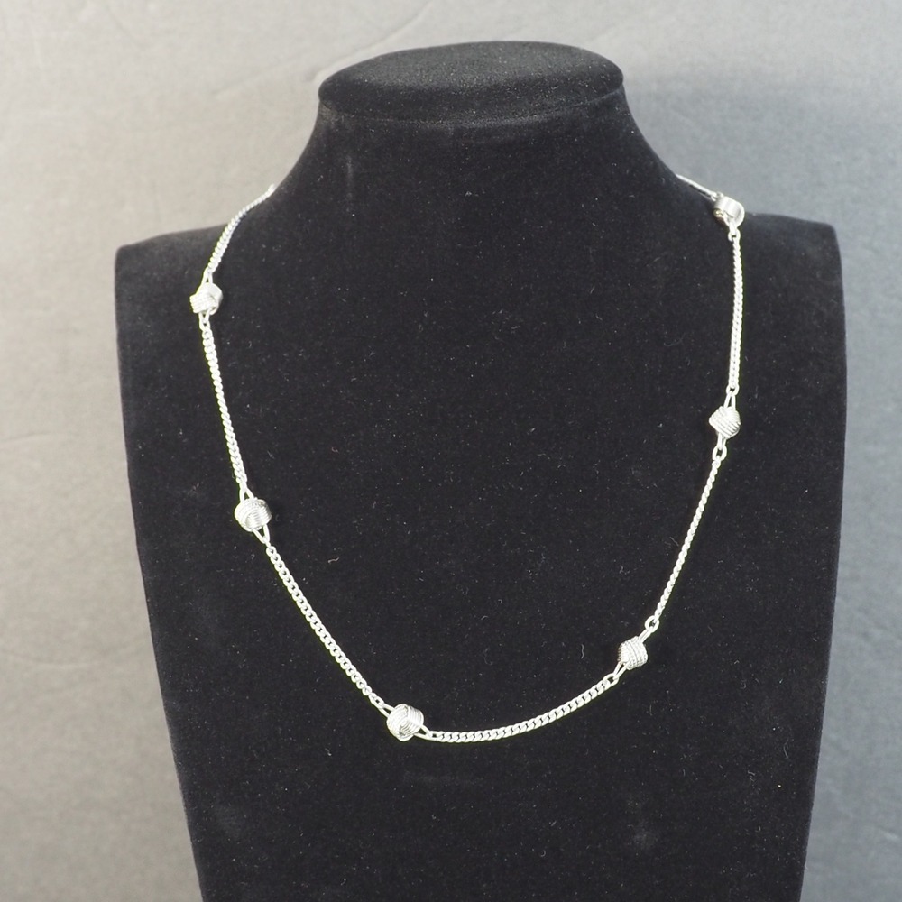 Avon Delicate Knot Necklace 1977 Silver Tone Textured Station Chain Vintage MCM